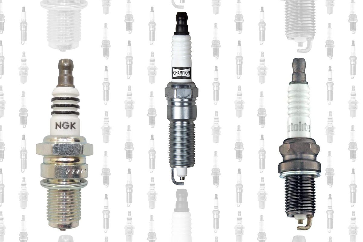 Three spark plugs against a backdrop of rows and rows of sparkplugs