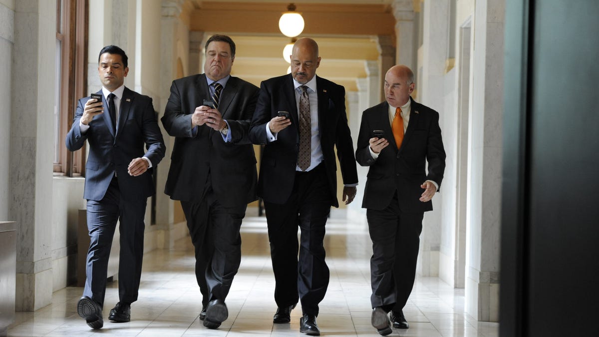 A shot from the show "Alpha House" of four characters walking down a hall