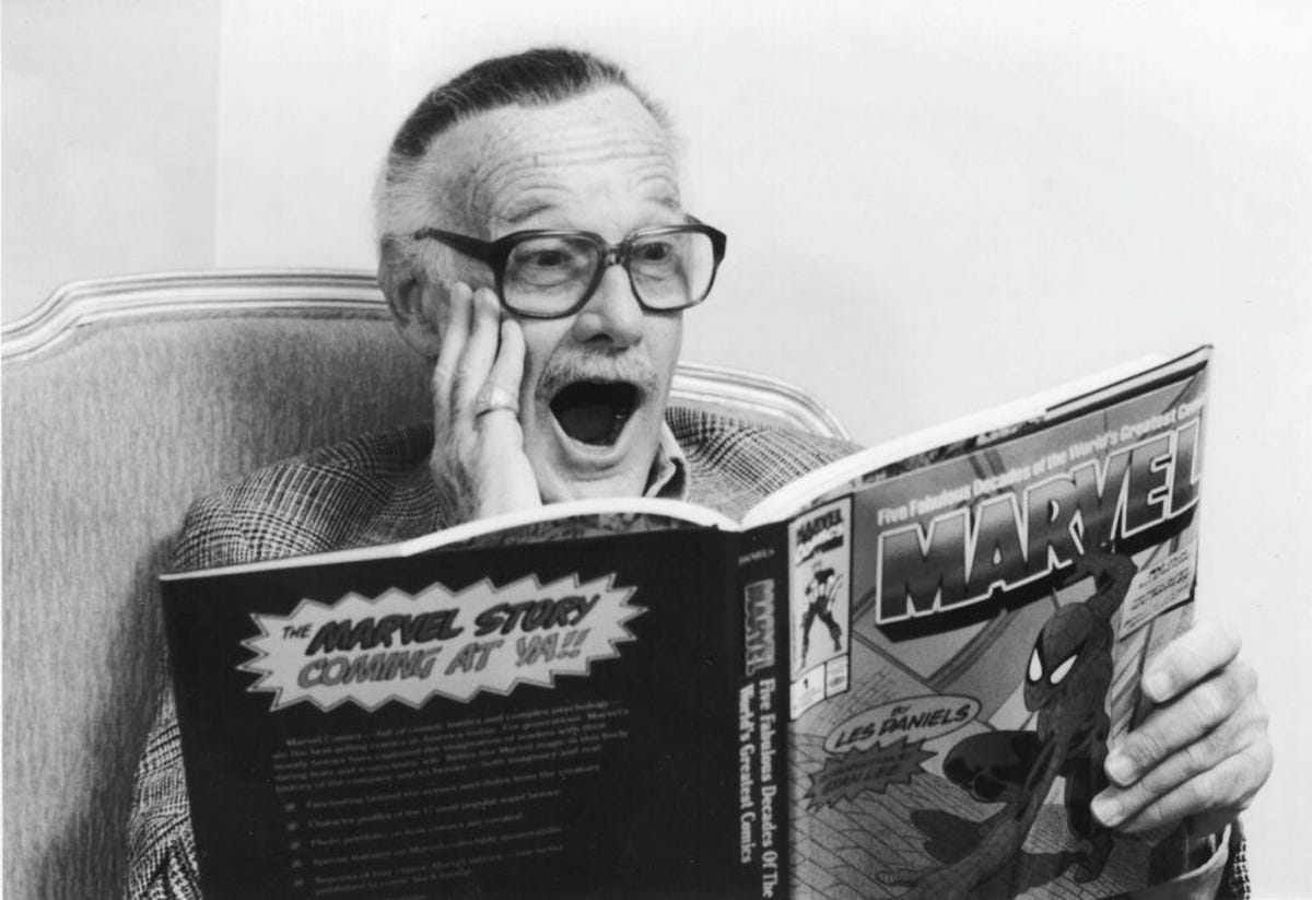 Stan Lee reading a Marvel comics collection in 1991