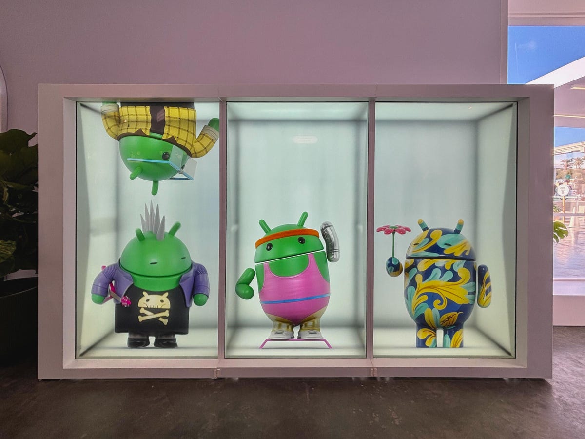 Four statues of Android mascots being playful