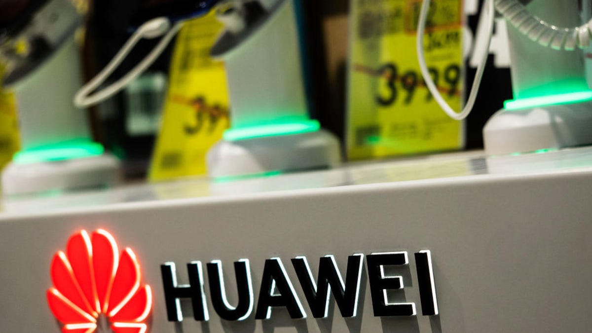Huawei logo seen at the shelf with smartphones in the store