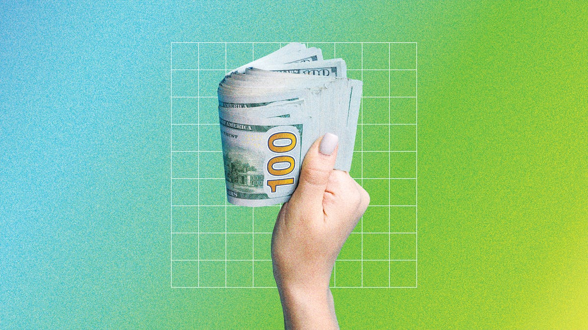 a hand holding dollar bills, in front of a green and blue background