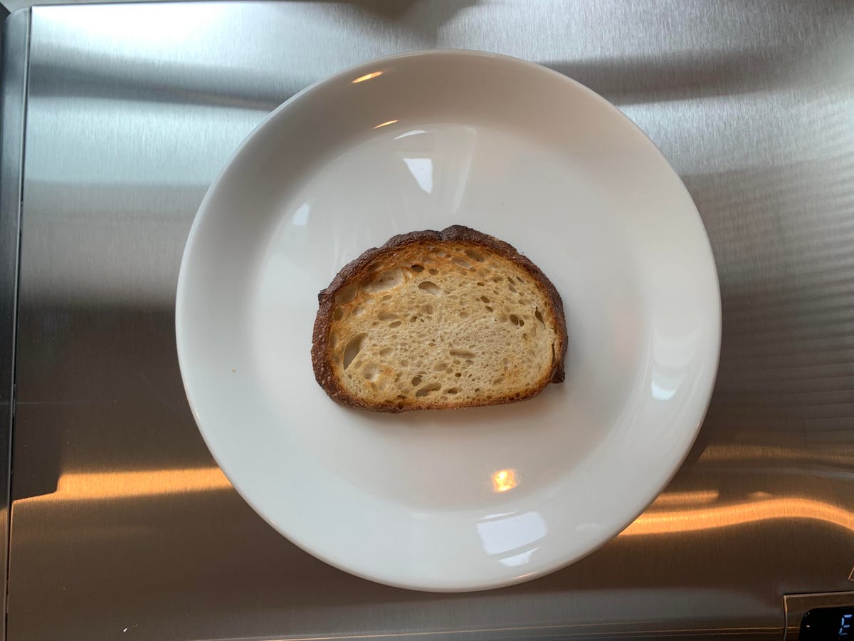 A piece of toast on a white plate. 