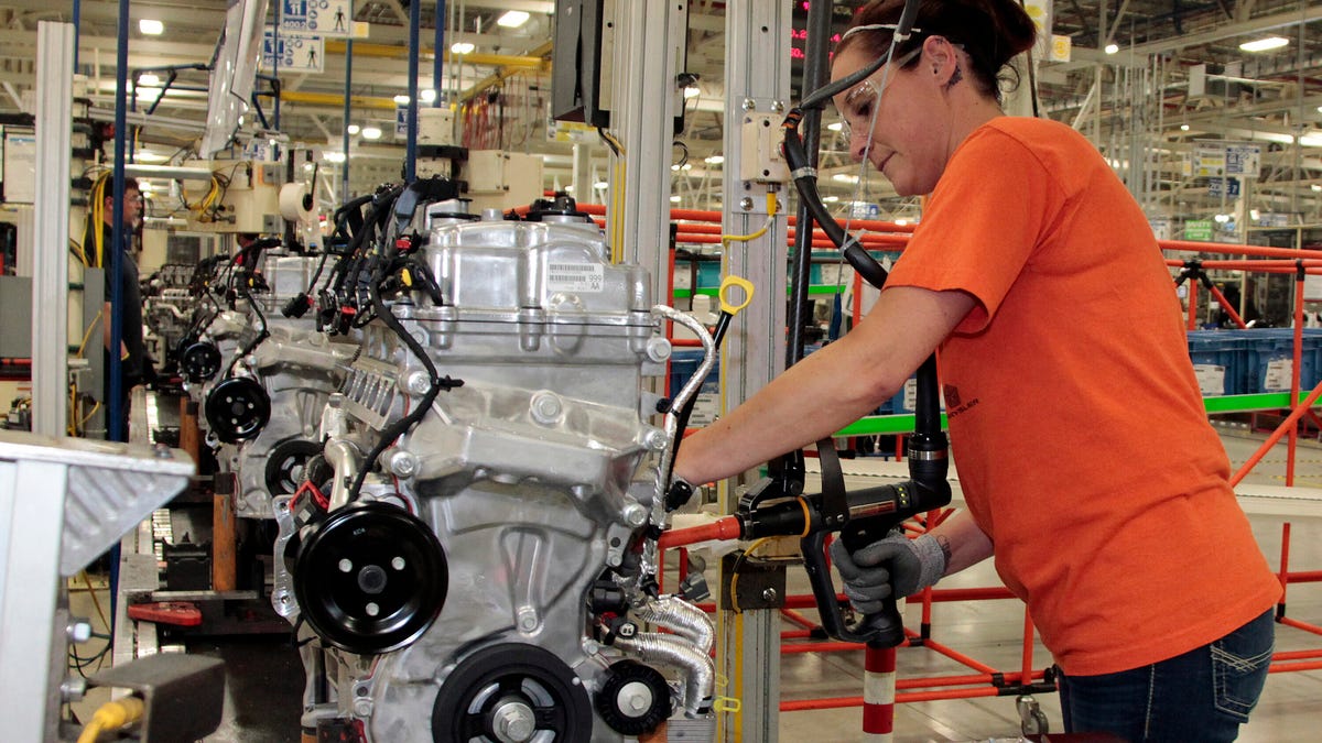 A worker builds a 2.4-liter Tigershark I4 at the Stellantis engine facility in Indiana