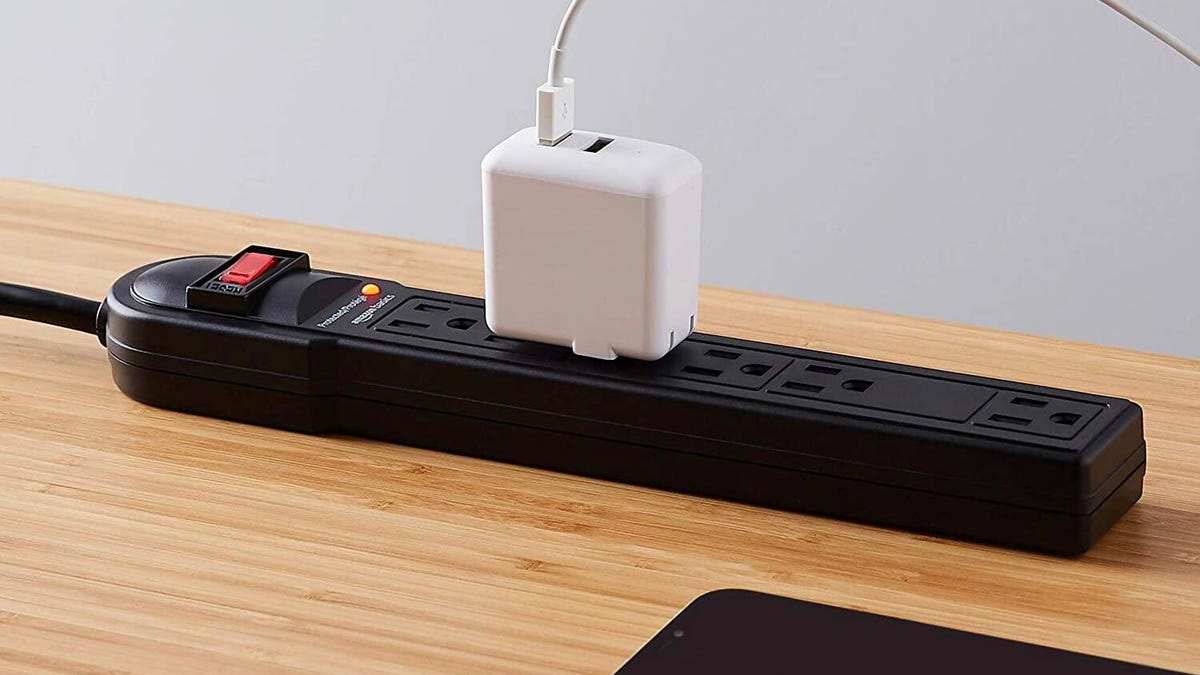 A power strip with a charger plugged in
