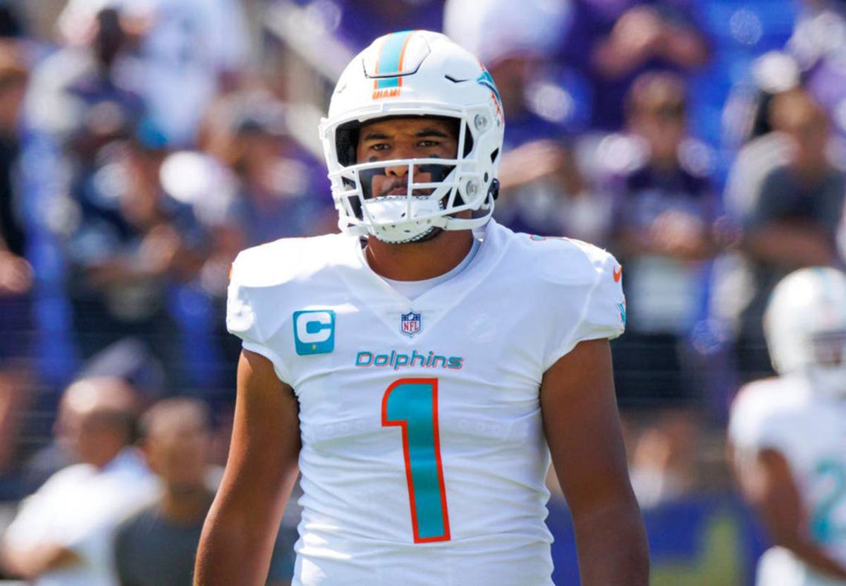 Tua Tagovailoa in the white and turquoise uniform of the Miami Dolphins