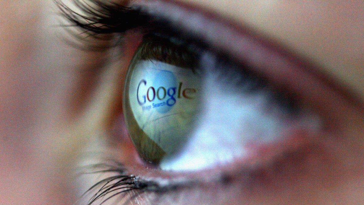 Google logo reflected in a human eye.