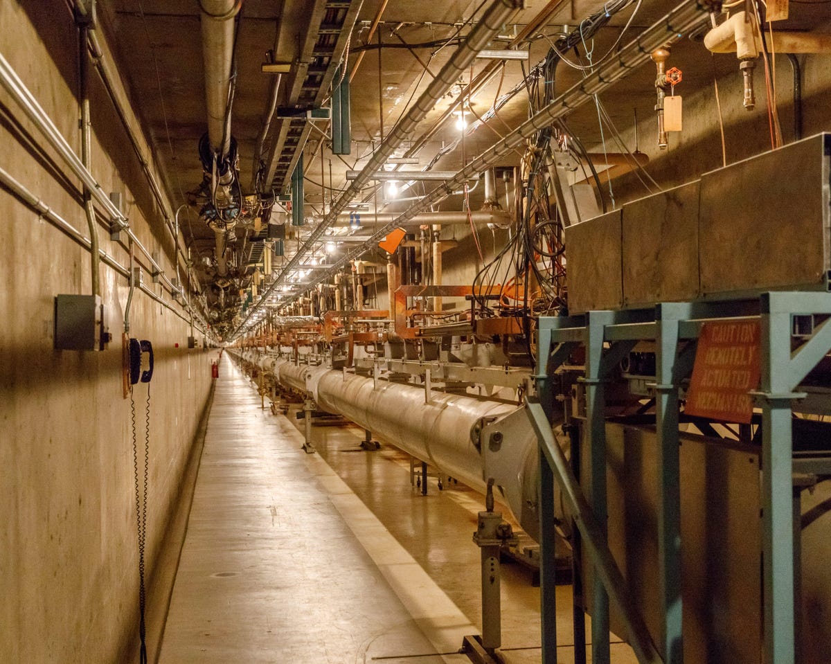This rarely seen section of SLAC shows the basic structure of a linear accelerator: the same equipment repeated over and over, each giving electrons a bit of a speed boost. SLAC uses 2 miles of copper cavities filled with radio waves to push electrons and their antiparticles, positrons, to high speed and high energy.