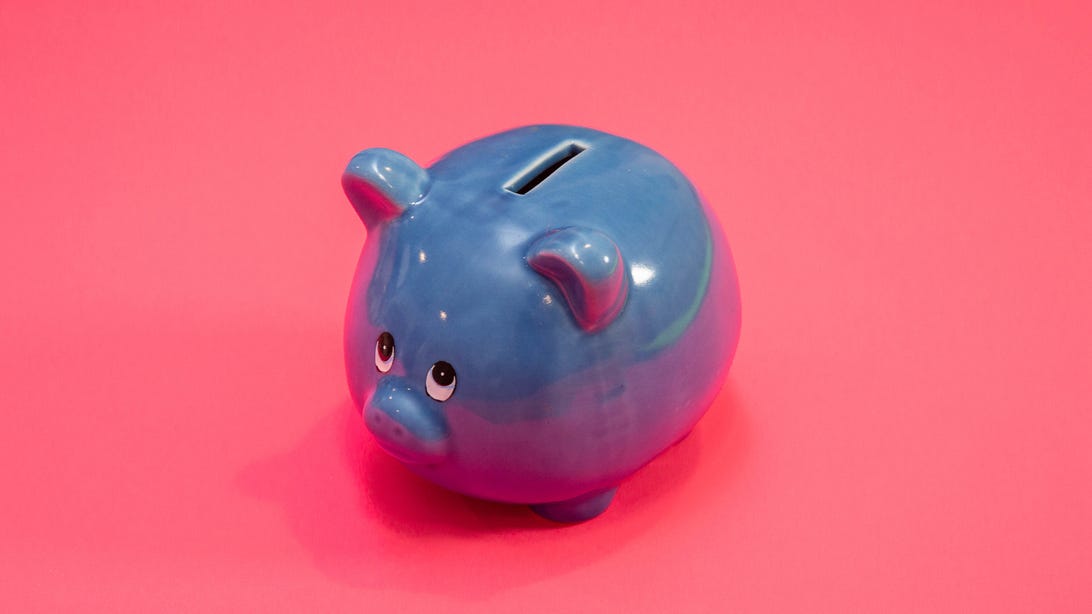 Small blue piggy bank with a grave expression