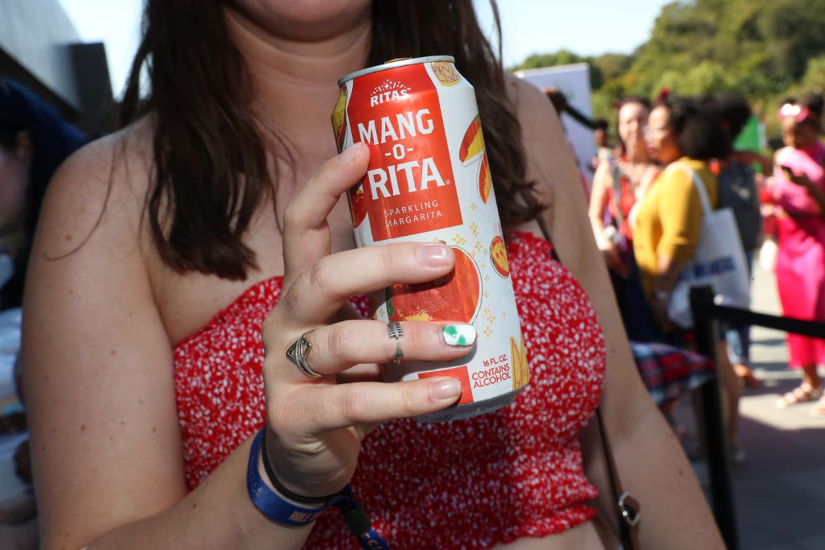 Woman holding can of mang-o-rita