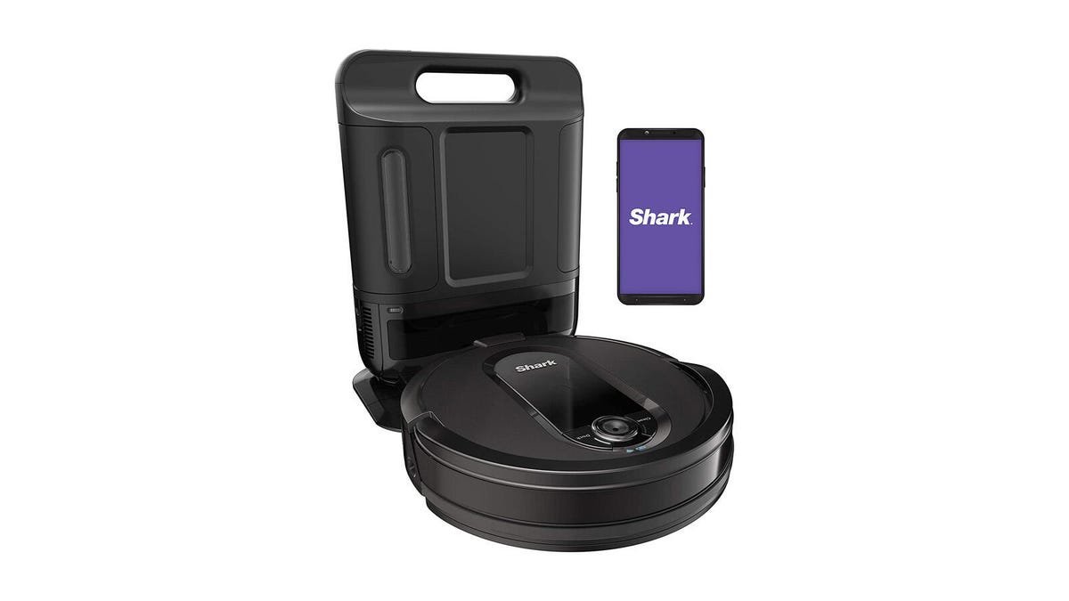 The Shark IQ Robot Vacuum AV1002AE with XL Self-Empty Base is pictured with a phone showing the Shark app against a white background.