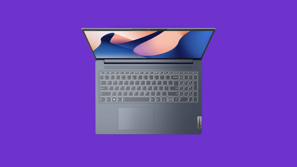 Lenovo IdeaPad Slim 5i laptop looking at keyboard on purple background.