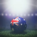 Soccer ball in flag colors on a bright blurred stadium background. Australia. 3D image