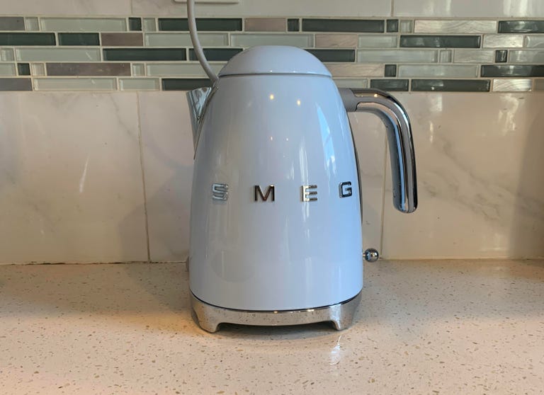 The Smeg electric kettle is located in front of the kitchen backsplash.  It's a good looking device, but it gets very hot to the touch during use.