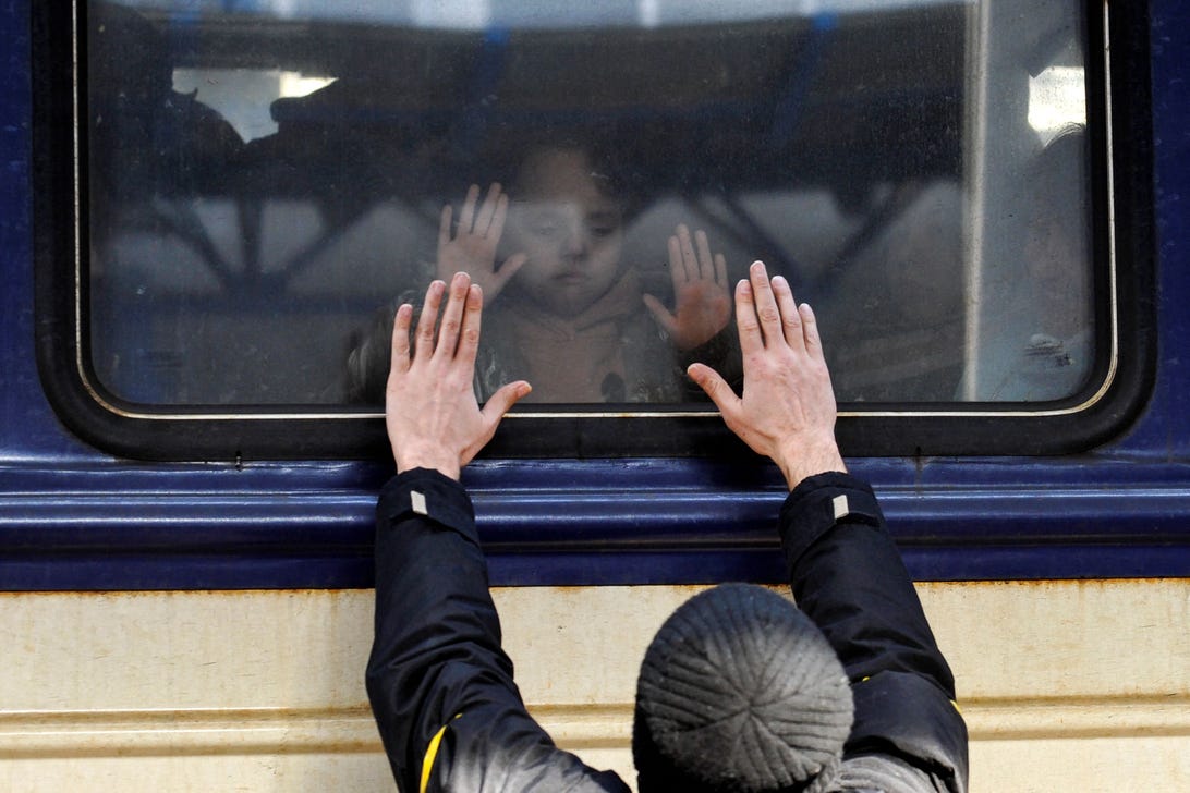 A man gestures in front of an evacuation train at Kyiv central train station in March.