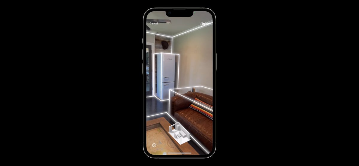 A room gets phone-scanned, with furniture and walls being outlined in glowing lines.