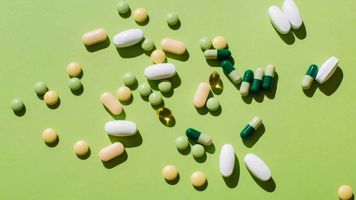 Pills and supplements againt a lime green background