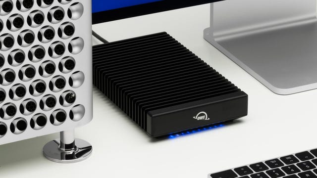a ThunderBlade X8 SSD placed between various high-end Mac products