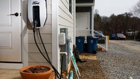 An electric vehicle charger on the side of a home.