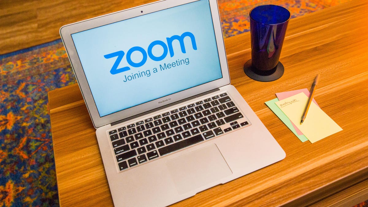 Zoom logo on a laptop in a living room