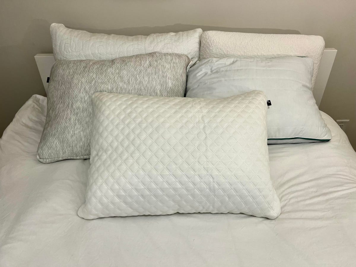 Five honorable mentions of cooling pillows on a white bed