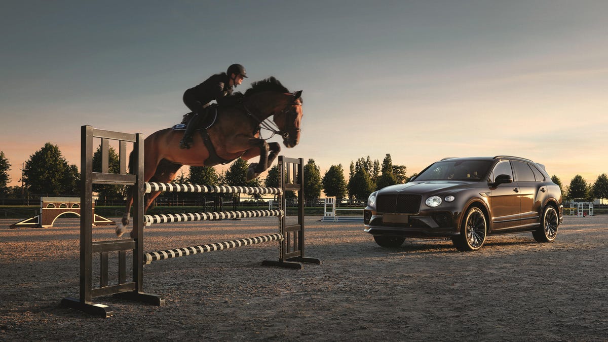Image of a horse jumping over an obstacle in front of a brown Bentley Bentayga Equestrian Collection