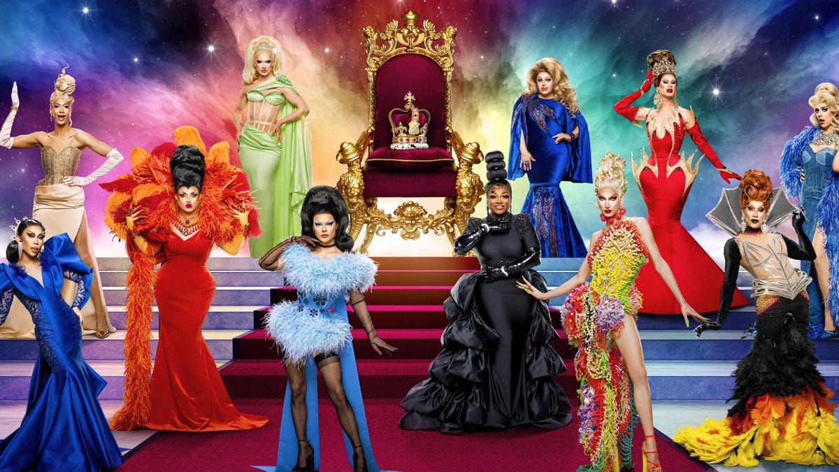 Composite image of all eleven contestants appearing on RuPaul's Drag Race: UK vs The World: Season 2 standing on stairs laid with red carpet. A throne with a crown stands in the middle.
