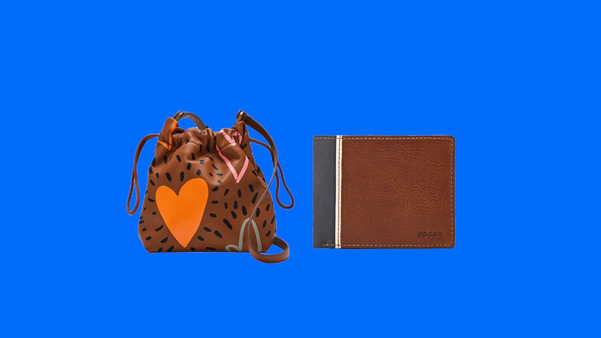 A brown crossbody bag with graphic hearts on it and a Fossil wallet next to each other