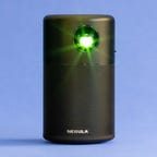 Anker Nebula Capsule projector shining a green light