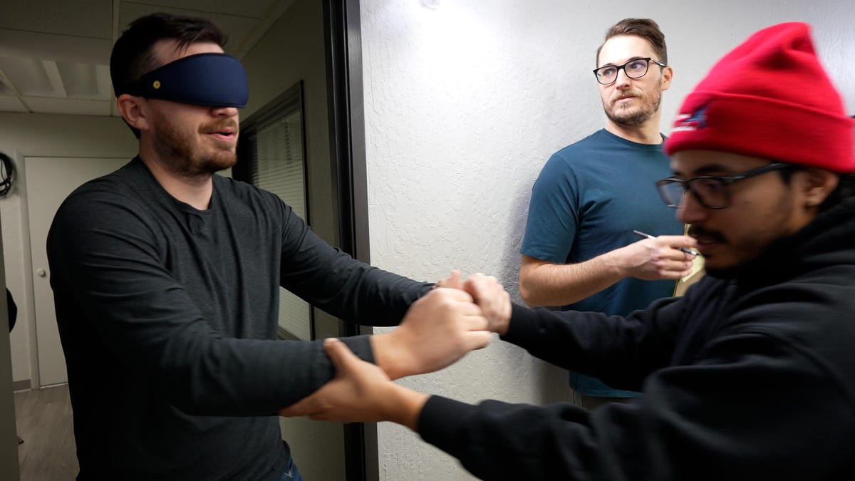 Our team helping Owen get into the mattress testing studio while blindfolded.