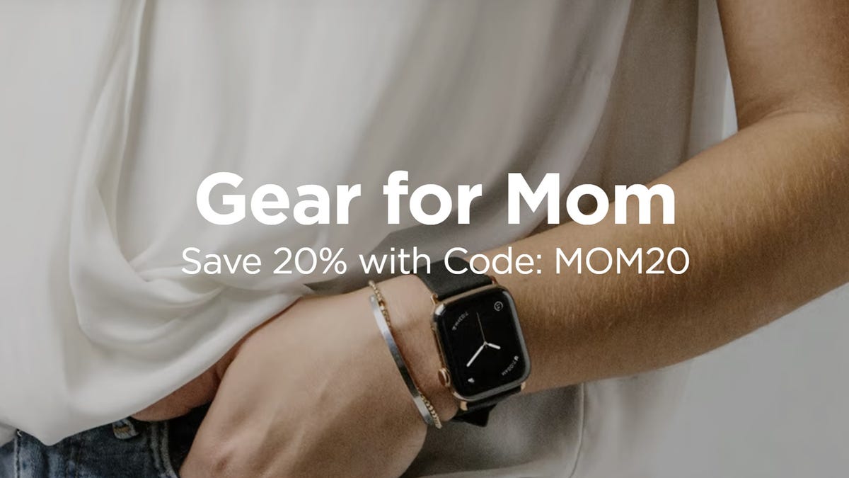 The wrist of a woman is shown to be wearing an Apple Watch with a Nomad band and a bracelet. The words "Gear for Mom" and "Save 20% with Code: MOM20" overlay the image.