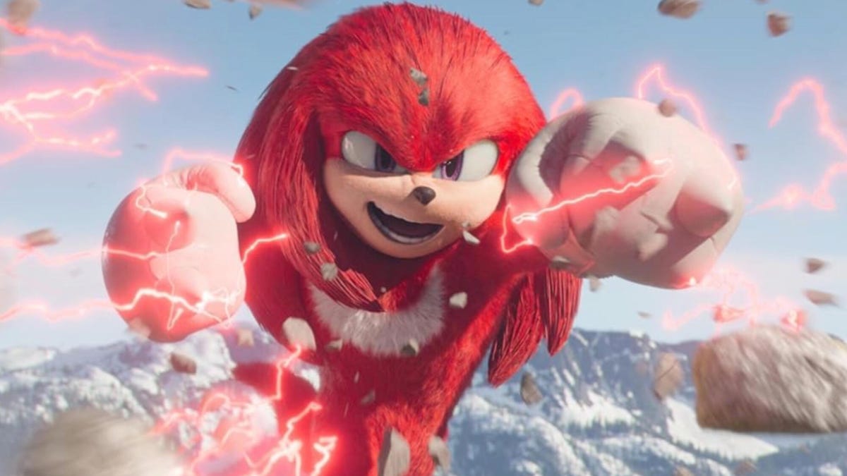 A still from the TV show Knuckles, showing the lead character smiling with red lightweight emanating from his hands.