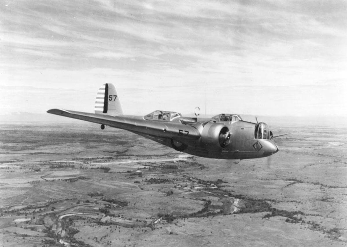 Martin B-10 in flight over open terrain