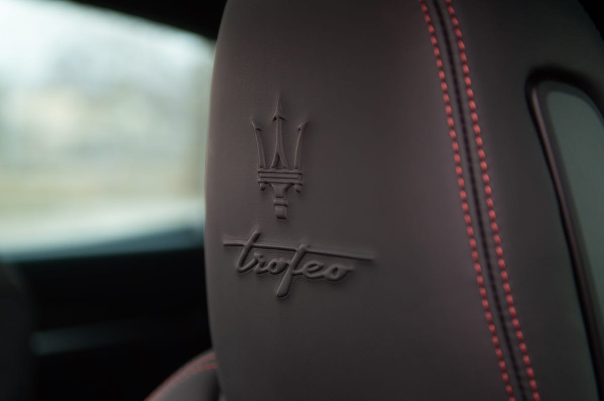 2022 Maserati Levante Trofeo in red, showing the embossed maserati badge in the headrests