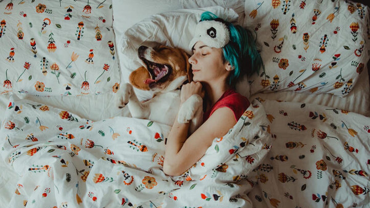 Woman and dog sleeping peacefully.
