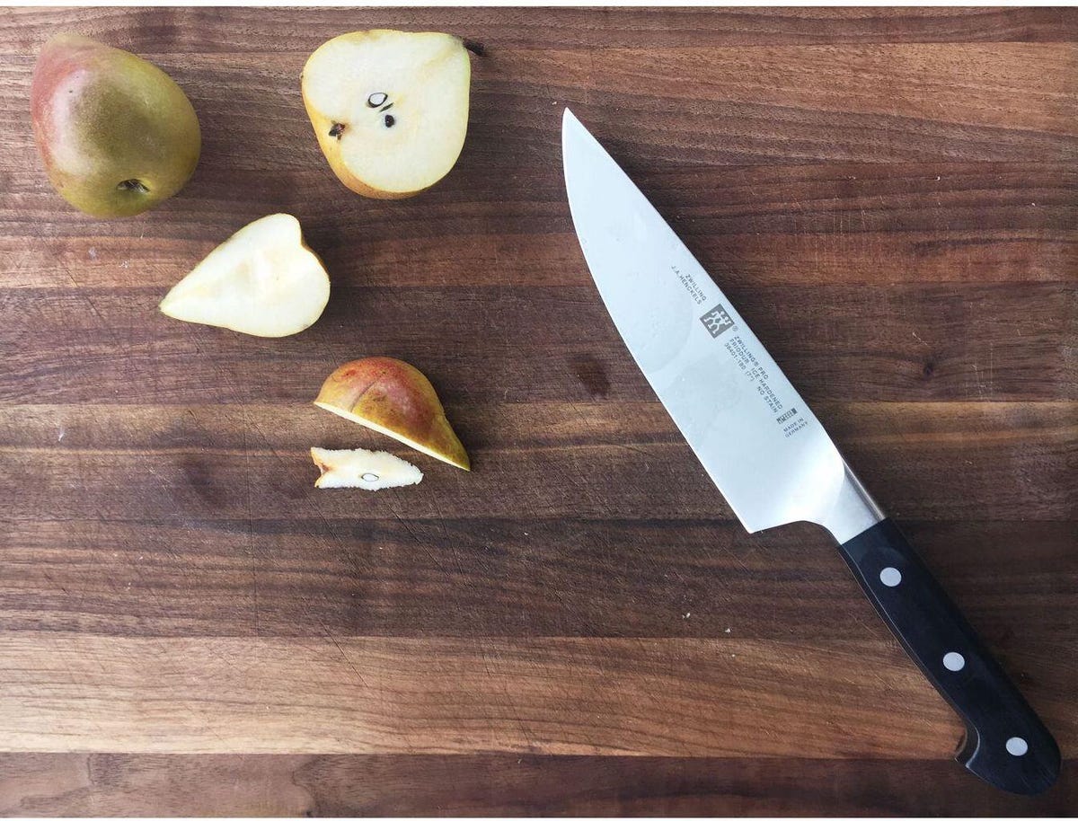 chefs knife on table with pears