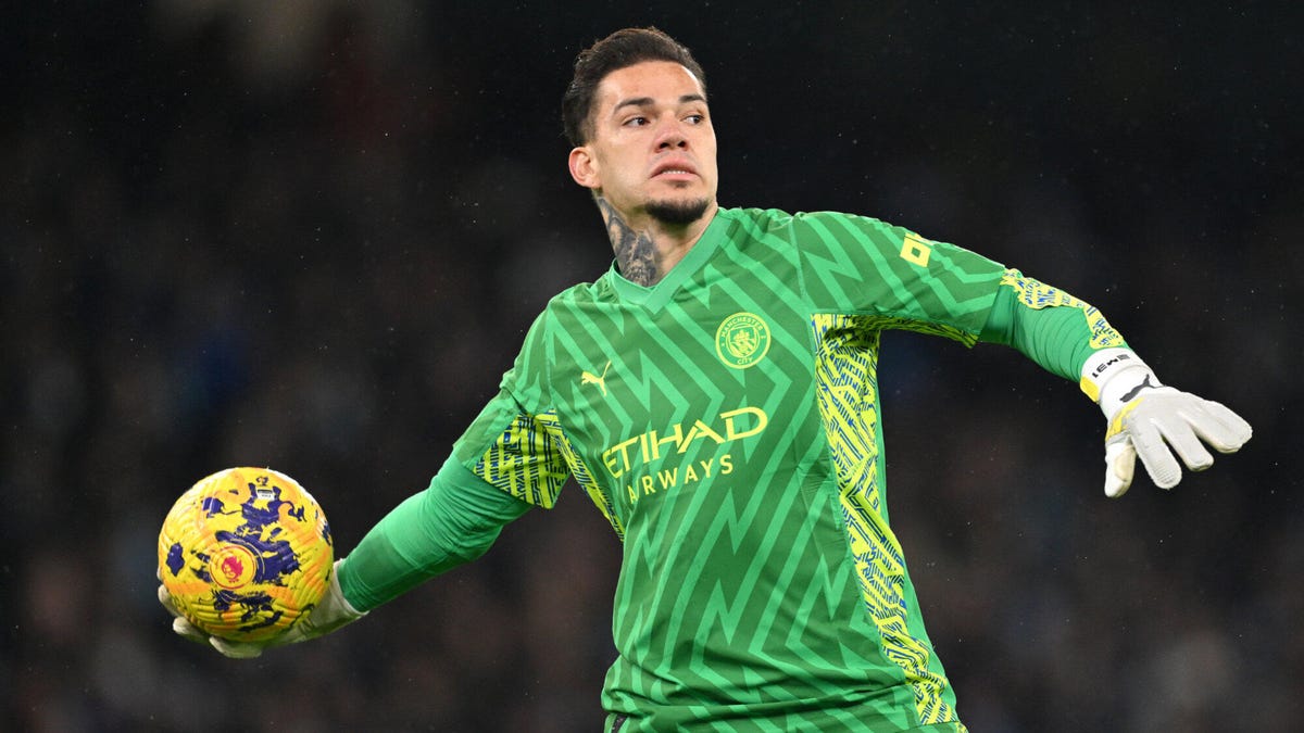 Manchester City goalkeeper Ederson arms outstretched about to throw a ball with his right hand.