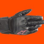 Alpinestars Stella Kalea leather motorcycle gloves on an orange background