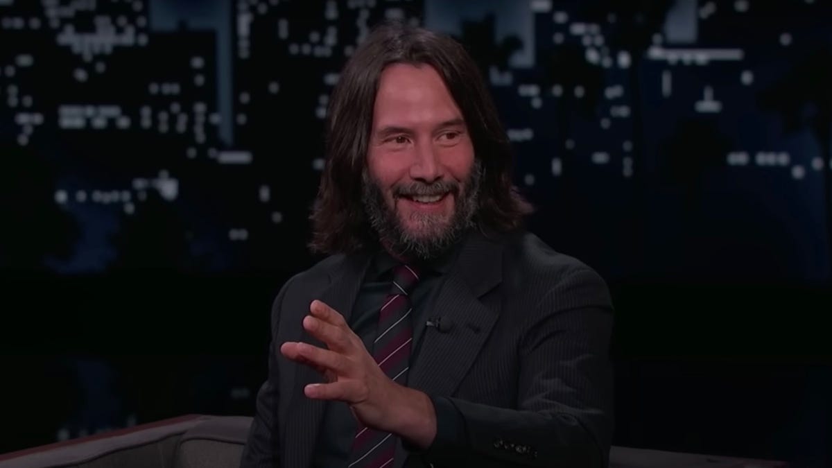 Keanu Reeves gestures while talking on Jimmy Kimmel