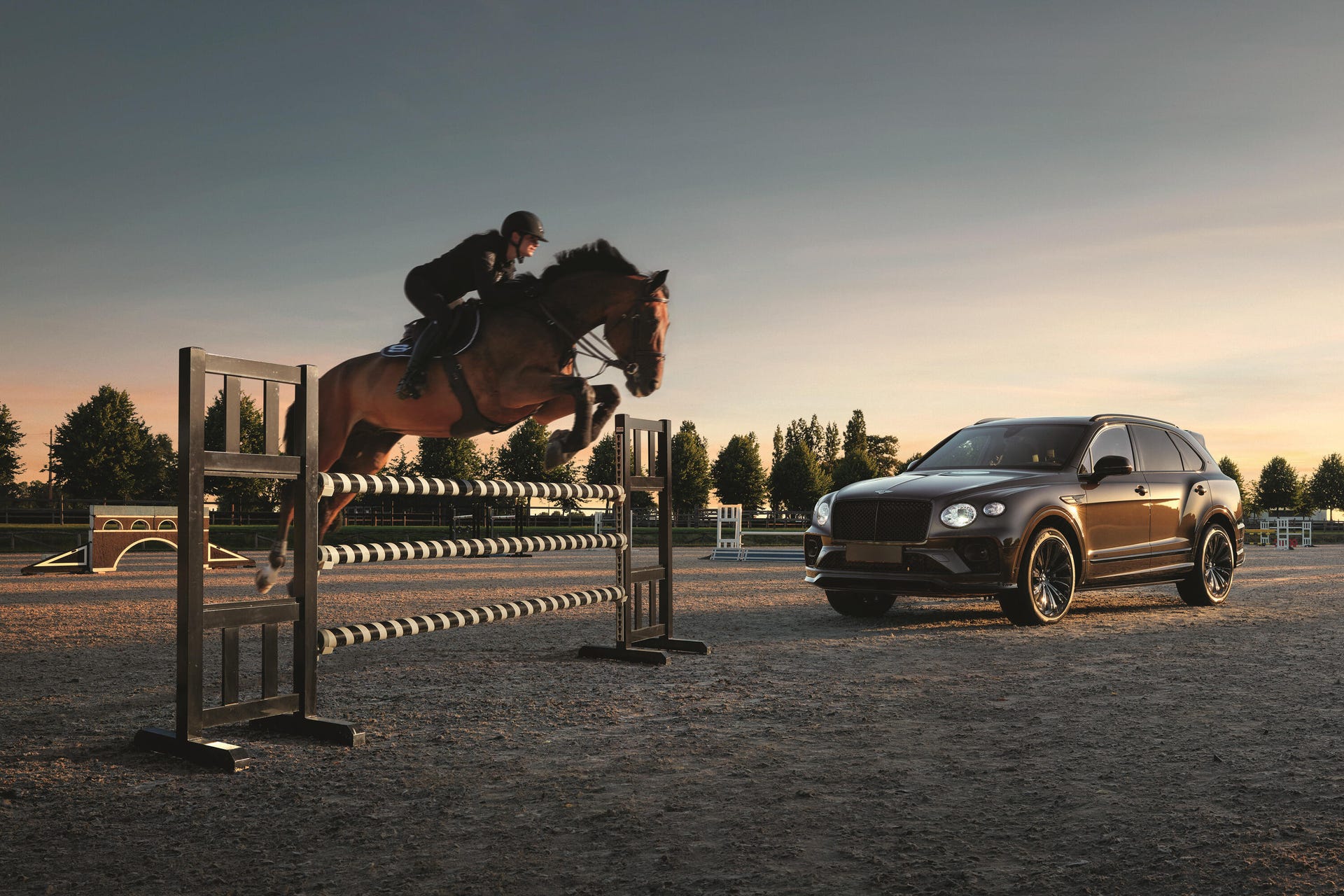 Image of a horse jumping over an obstacle in front of a brown Bentley Bentayga Equestrian Collection