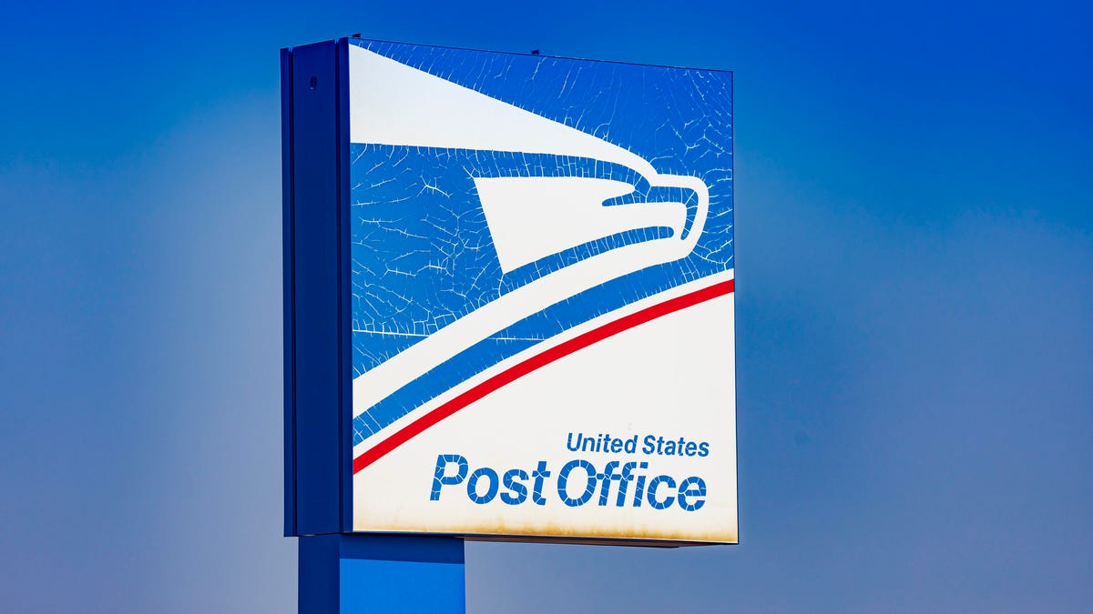 The USPS sign at a post office