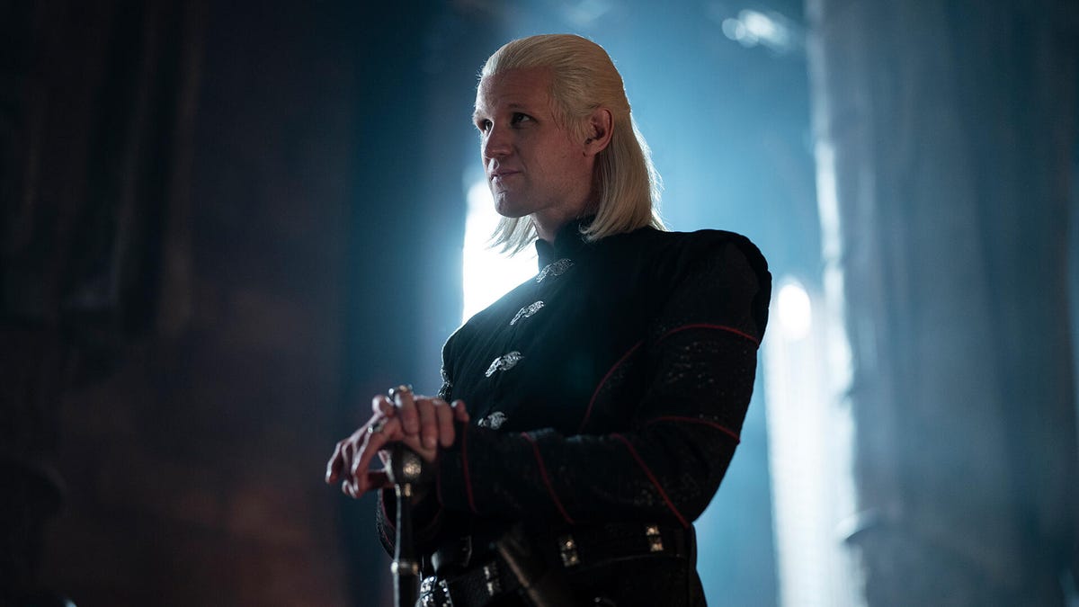 Daemon Targaryen, looking smug, backlit in a castle interior
