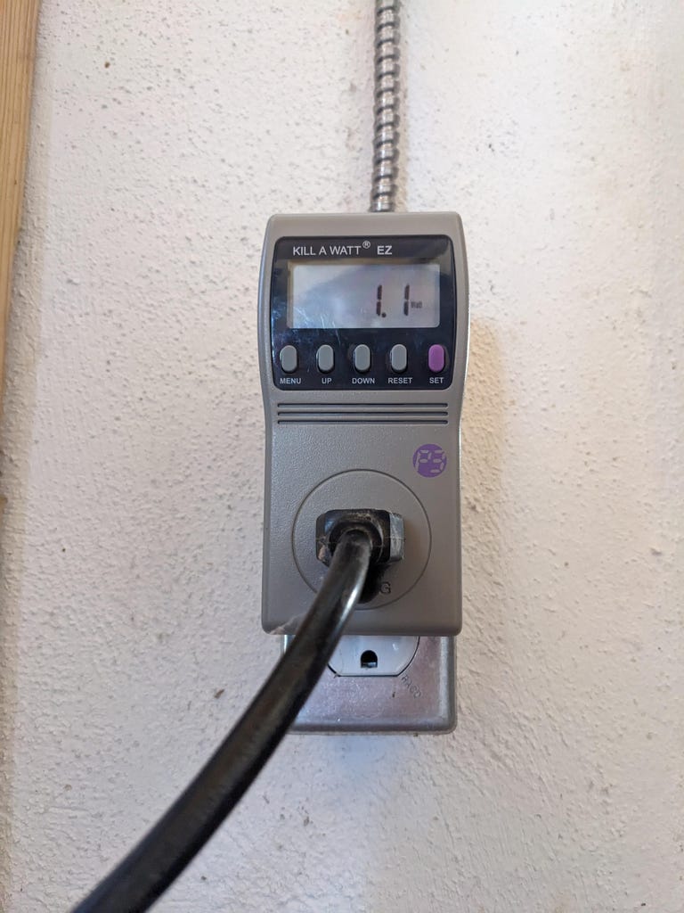 A cord plugged into a Kill A Watt meter.