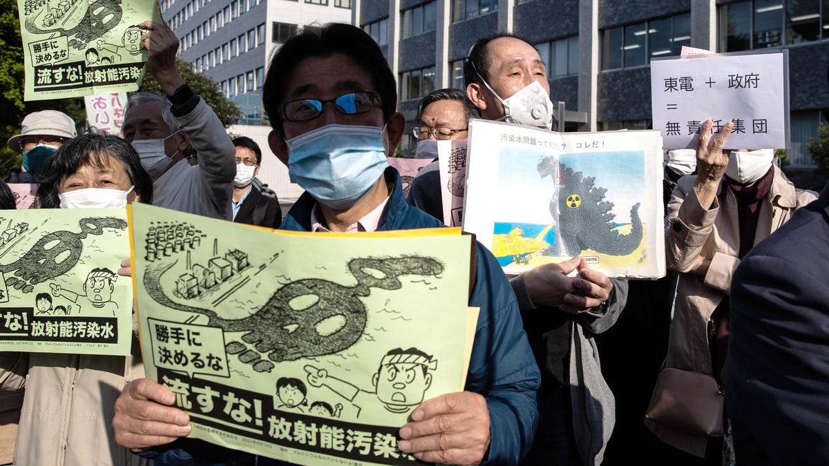 People with signs protesting Japan's plan to release contaminated water from Fukushima into the ocean