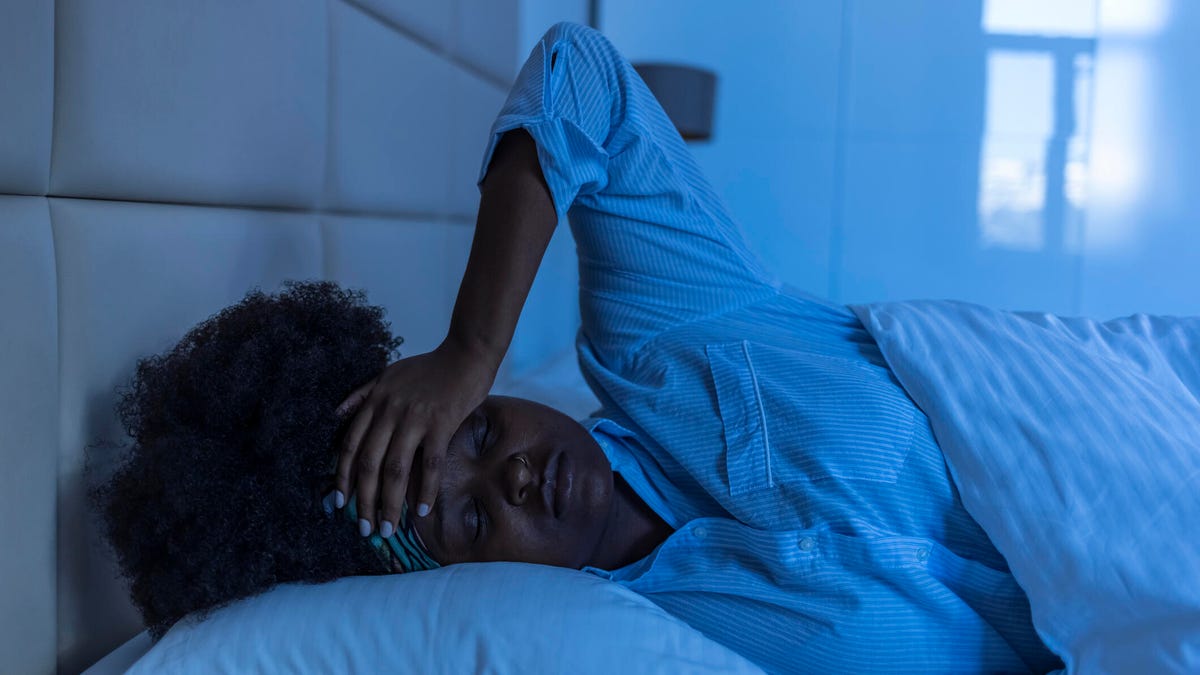 Woman lying in bed, can&apos;t sleep