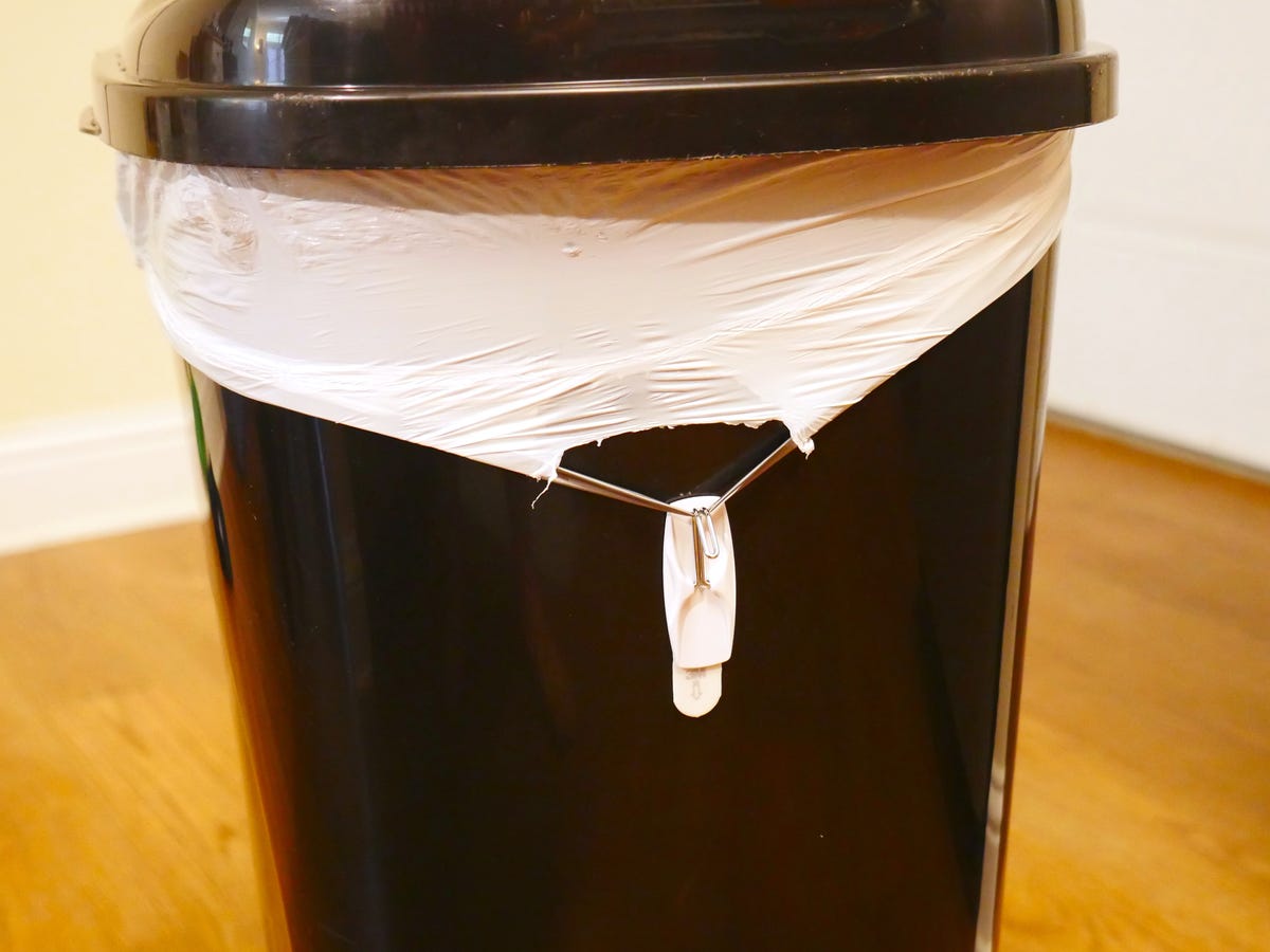 The genius trick that keeps trash bags from falling in - CNET