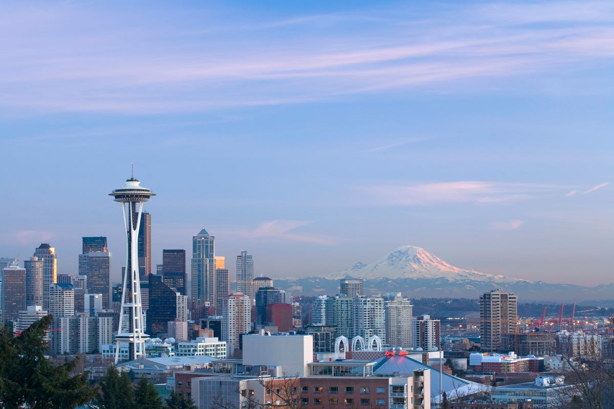 The Seattle skyline featuring the Space Needle with Mount Rainier in the background.