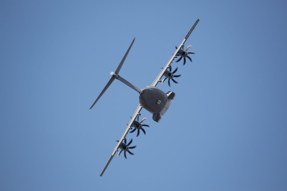 The Airbus A400M flies in a steeply banked turn.
