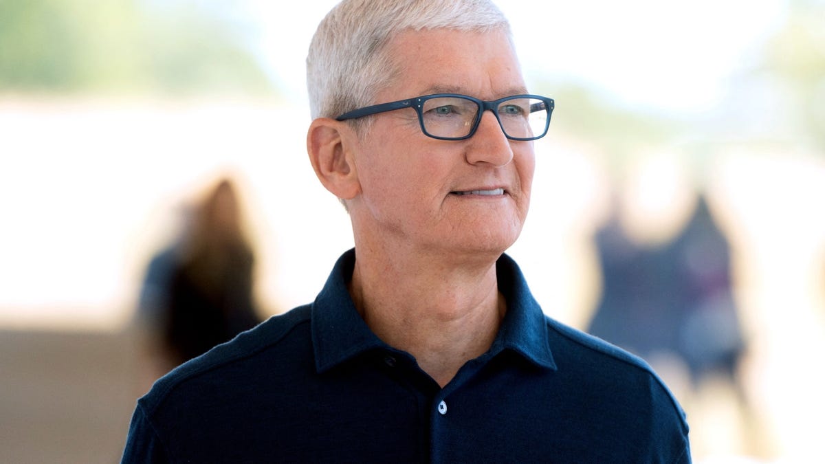 Tim Cook stands outside on the Apple Park campus