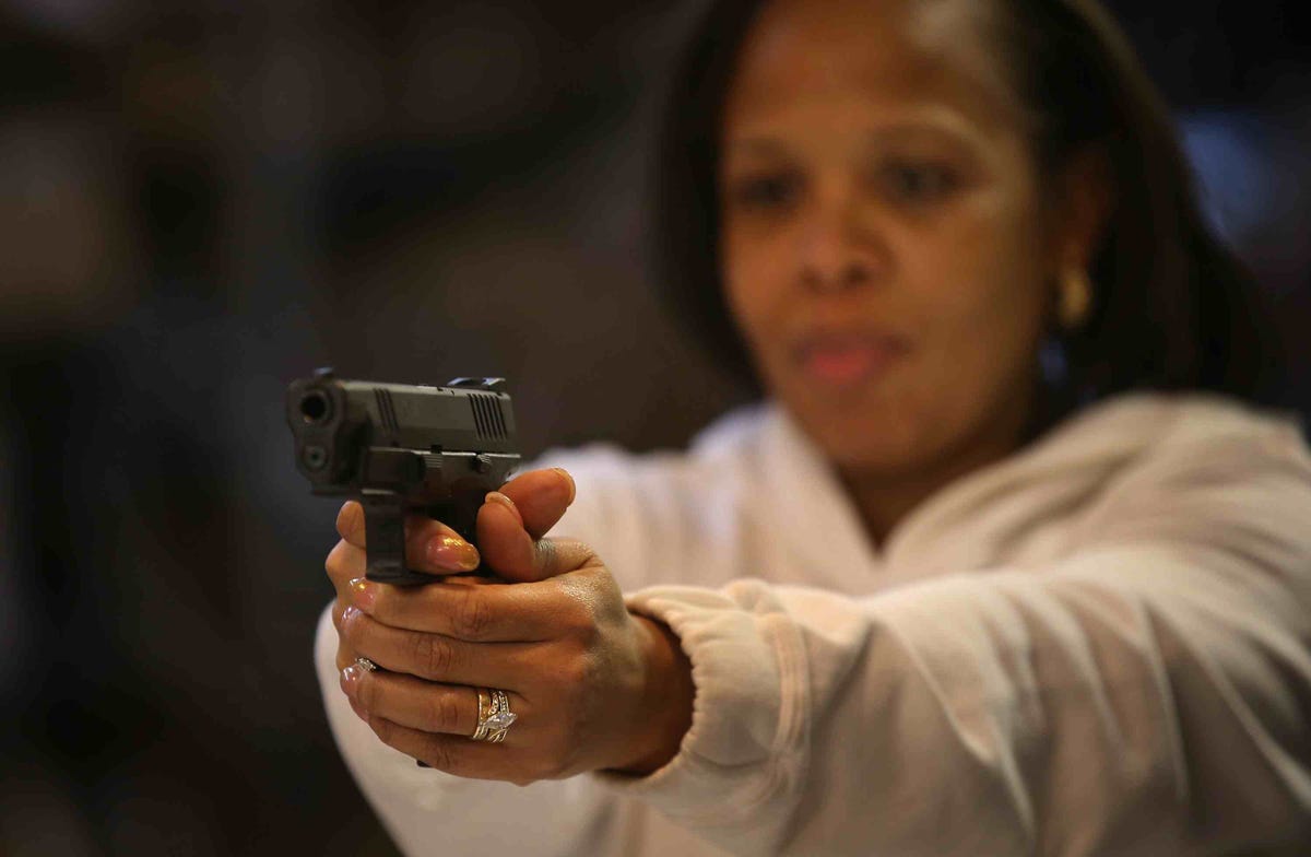 A woman learns how to fire a handgun during a basic pistol course, in this file photo, held during Gun Appreciation Day.